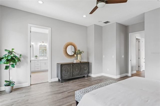 bedroom with baseboards, wood finished floors, and recessed lighting