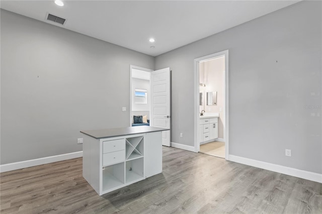 unfurnished office with light wood-style floors, baseboards, visible vents, and recessed lighting