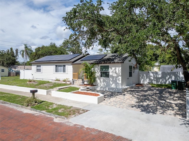 view of front of home featuring solar panels