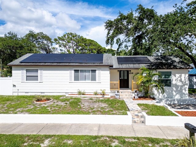 view of front of property with solar panels