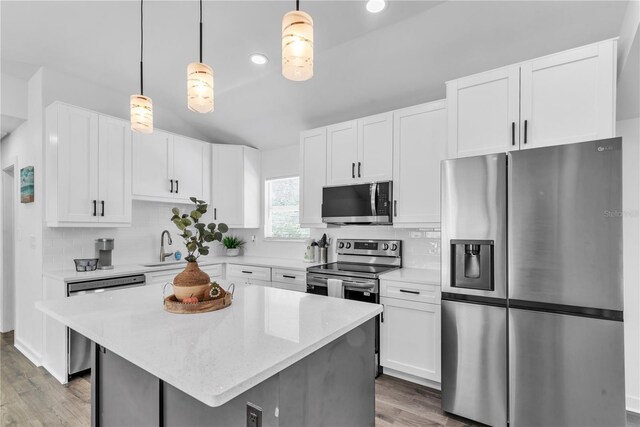 kitchen featuring light hardwood / wood-style flooring, white cabinets, tasteful backsplash, and stainless steel appliances