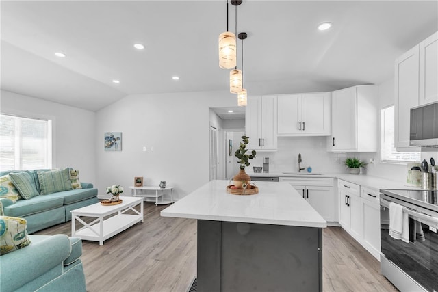 kitchen featuring white cabinetry, sink, light wood-type flooring, and stainless steel electric range oven