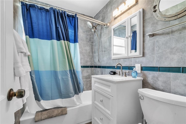 full bathroom featuring tile walls, toilet, vanity, and shower / tub combo with curtain