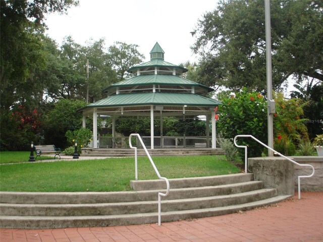 view of property's community featuring a lawn and a gazebo