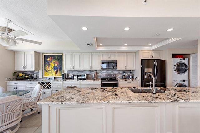 kitchen featuring backsplash, a raised ceiling, range with electric cooktop, and refrigerator with ice dispenser