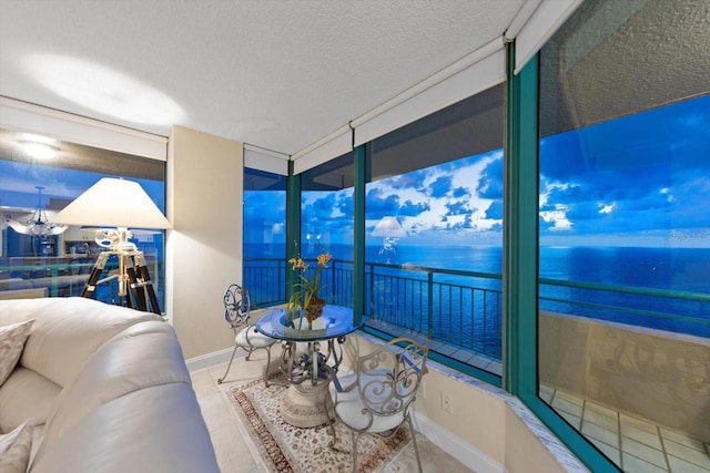 sunroom / solarium featuring a water view