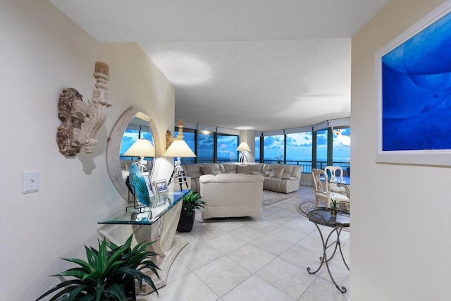 living room with expansive windows and light tile patterned floors