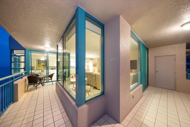 interior space featuring a textured ceiling and light tile patterned floors