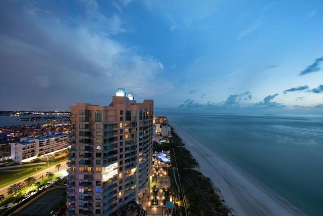 bird's eye view with a water view, a view of the beach, and a city view