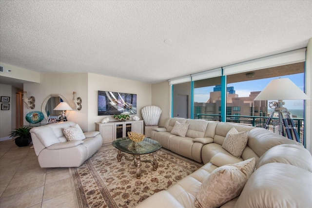 living room featuring a textured ceiling and light tile patterned floors