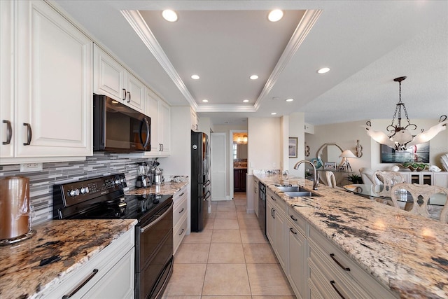 kitchen with black appliances, a sink, decorative backsplash, white cabinetry, and a raised ceiling