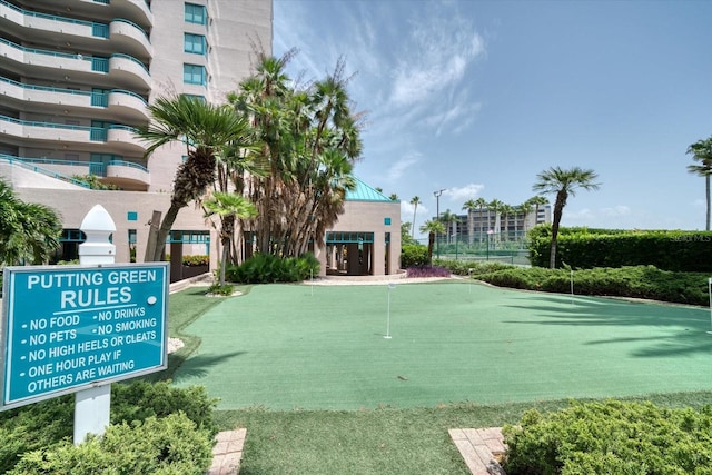 view of property's community with a putting area