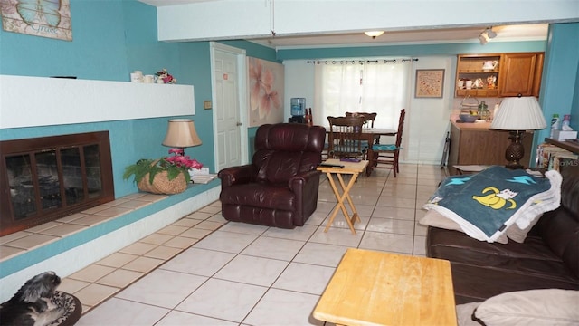 living room featuring light tile patterned flooring and a tile fireplace