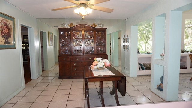 tiled dining space featuring ceiling fan