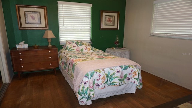 bedroom with wood-type flooring and multiple windows