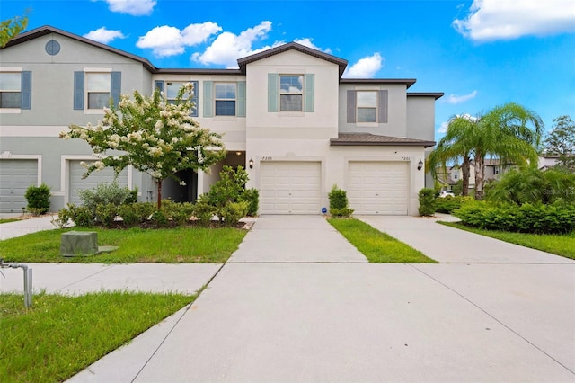 7203 Sweet Alyssum Ct, Tampa, FL 33619 - view of property featuring a garage, driveway, and stucco siding