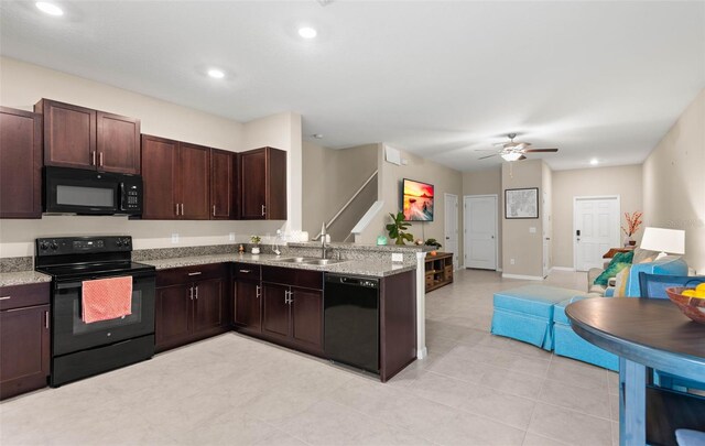 kitchen featuring black appliances, light stone counters, sink, kitchen peninsula, and ceiling fan