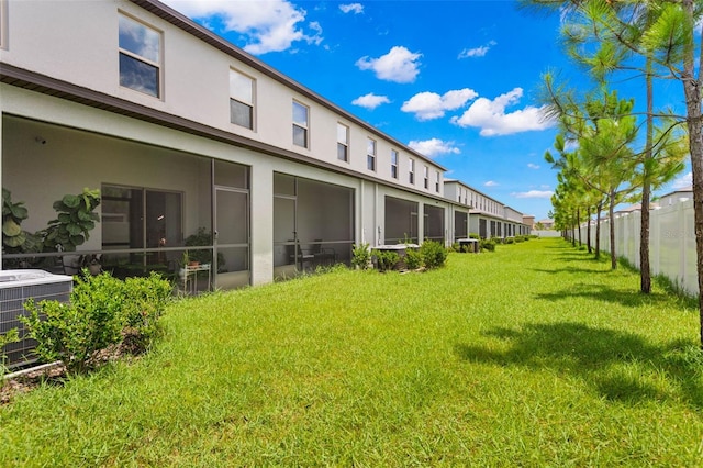 7203 Sweet Alyssum Ct, Tampa, FL 33619 - view of yard featuring a sunroom, fence, and central AC