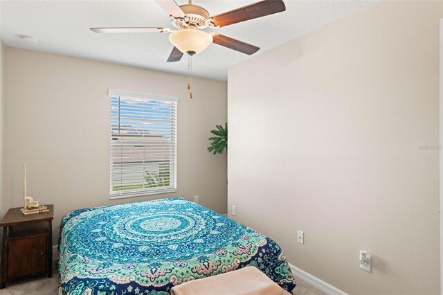 bedroom featuring light colored carpet and ceiling fan