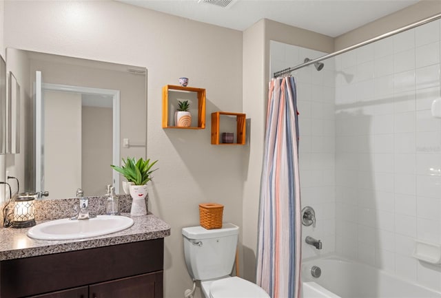 full bathroom featuring shower / bath combo, vanity, and toilet