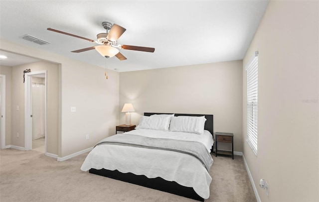 bedroom featuring ceiling fan and light carpet