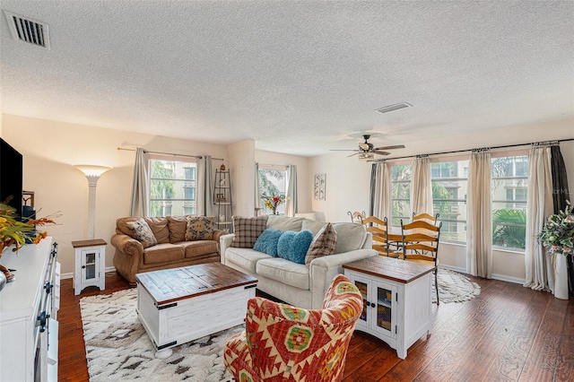 living room featuring a textured ceiling, ceiling fan, and hardwood / wood-style floors