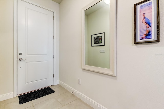 doorway with light tile patterned floors