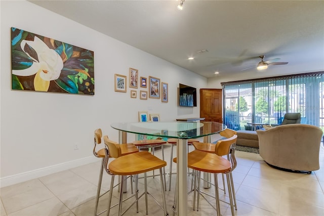 tiled dining room featuring ceiling fan