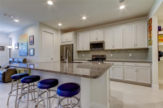 kitchen with white cabinetry, sink, a center island with sink, and appliances with stainless steel finishes