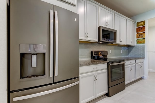 kitchen featuring tasteful backsplash, stone counters, white cabinets, and appliances with stainless steel finishes