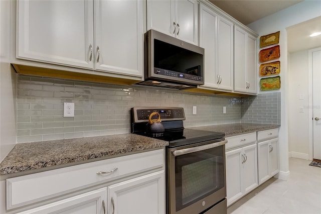 kitchen featuring light stone counters, white cabinetry, appliances with stainless steel finishes, and tasteful backsplash