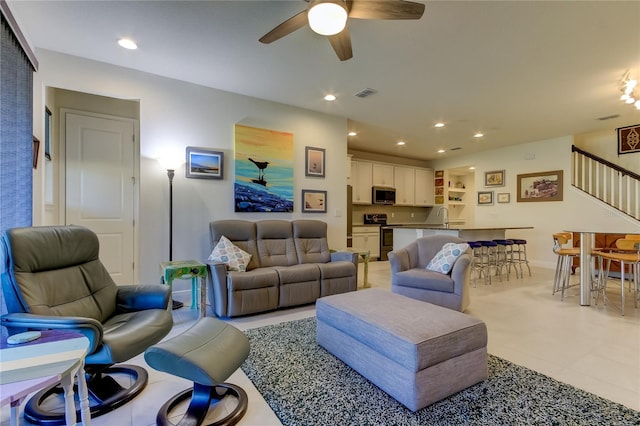 living room with ceiling fan and sink