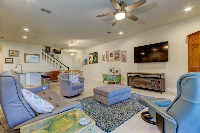 living room featuring sink and ceiling fan