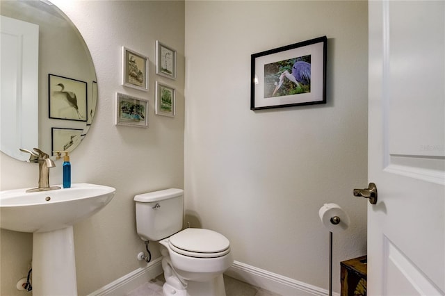 bathroom featuring tile patterned floors and toilet