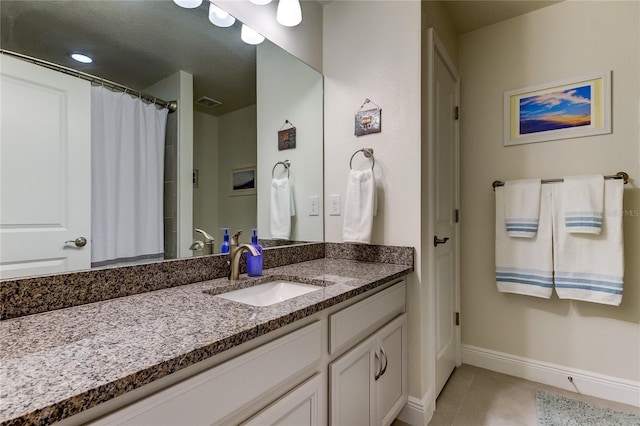 bathroom featuring tile patterned flooring, vanity, and a shower with shower curtain