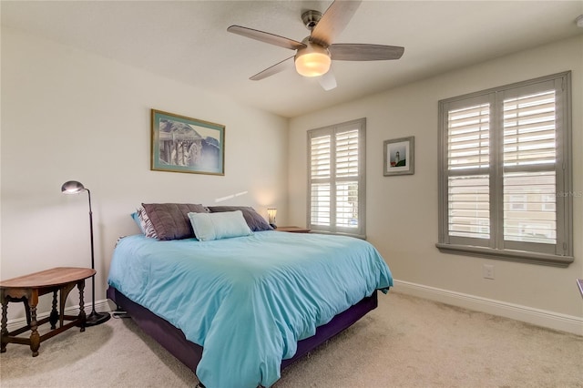 bedroom with ceiling fan and light carpet