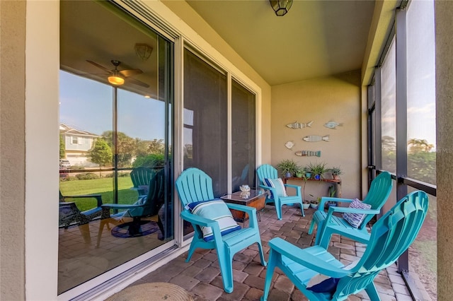 sunroom featuring ceiling fan