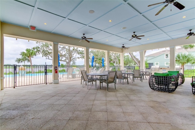 view of patio / terrace featuring ceiling fan, a community pool, and a playground