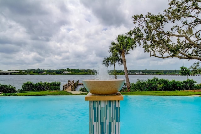 view of swimming pool featuring a water view