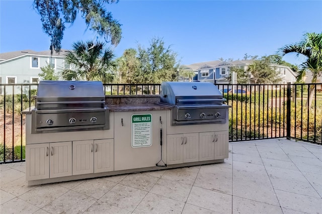 view of patio with area for grilling and a grill