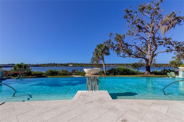 view of pool with a water view