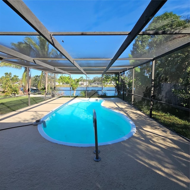 view of pool featuring glass enclosure and a patio area