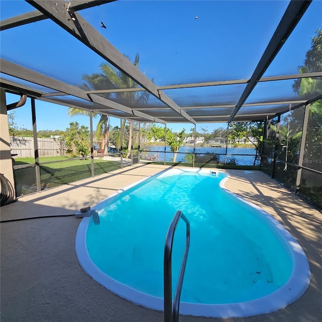 view of pool with a patio and glass enclosure