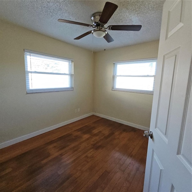 unfurnished room featuring dark hardwood / wood-style floors and a textured ceiling