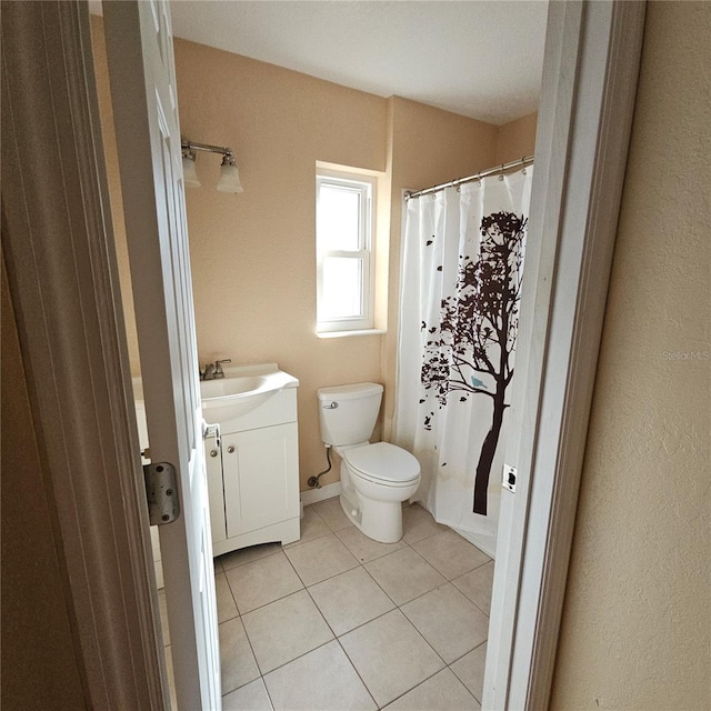 bathroom with vanity, tile patterned floors, and toilet