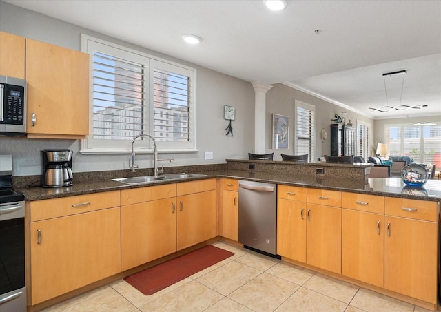 kitchen with crown molding, dark stone countertops, sink, and stainless steel appliances