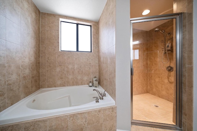 bathroom with a garden tub and a shower stall