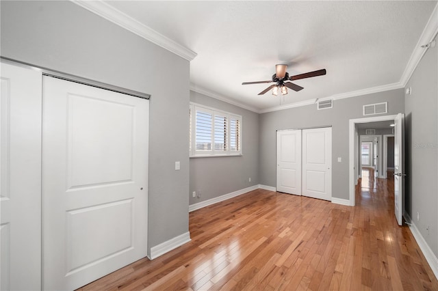 unfurnished bedroom featuring visible vents and crown molding