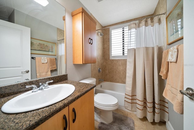 bathroom with toilet, vanity, shower / bath combo with shower curtain, and tile patterned floors