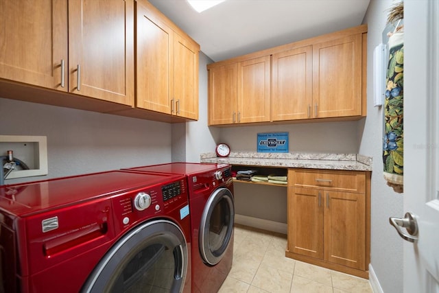 washroom with washer and clothes dryer, light tile patterned flooring, cabinet space, and baseboards